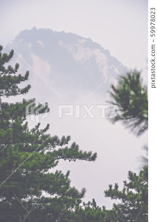 Peak covered in fog as seen from Huashan mountain 59978023