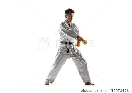 Confident korean man in kimono practicing hand-to-hand combat, martial arts 59978578