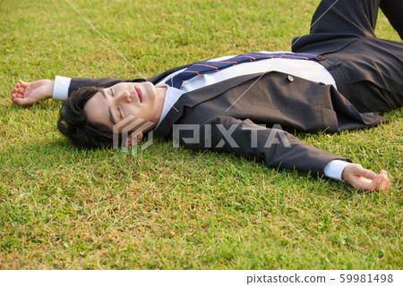 Businessman park lie down 59981498