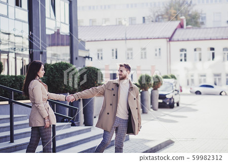 Beautiful young couple holding hands Beautiful young couple holding hands 59982312