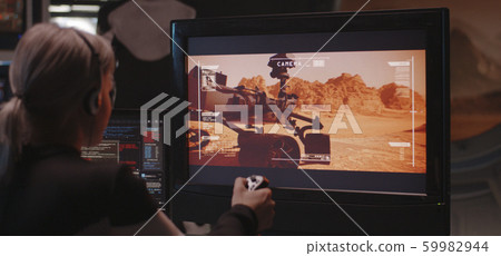 Woman controlling Mars rover with remote controller Woman controlling Mars rover with remote controller 59982944