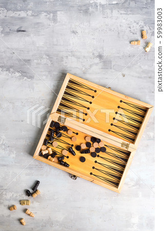 backgammon dice and pieces with a pair of chess pieces on the stone background, flat lay backgammon dice and pieces with a pair of chess pieces on the stone background, flat lay 59983003