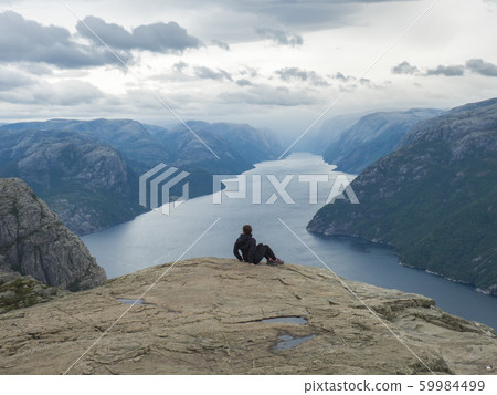 Hiker woman admiring view on fjord Lysefjord from 59984499