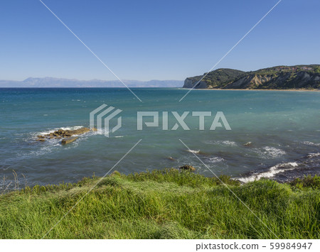 View on agios stefanos beach and bay with lush View on agios stefanos beach and bay with lush 59984947