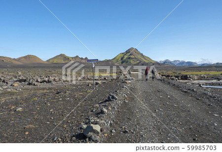 Icelandic lava desert landscape with two man Icelandic lava desert landscape with two man 59985703