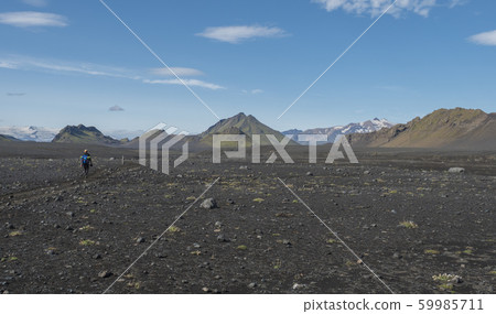 Icelandic lava desert landscape with man hiker on 59985711