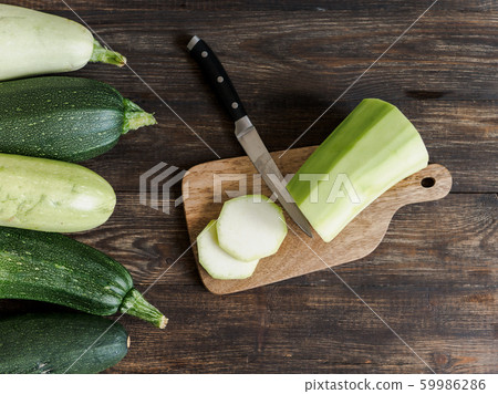 Zucchini harvesting concept. 59986286