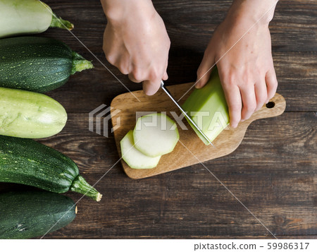 Zucchini harvesting concept. 59986317