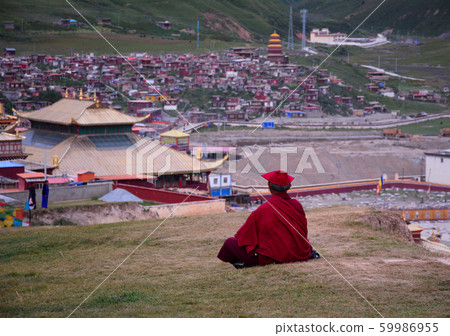 Tibetan monks sitting on the hill Tibetan monks sitting on the hill 59986955