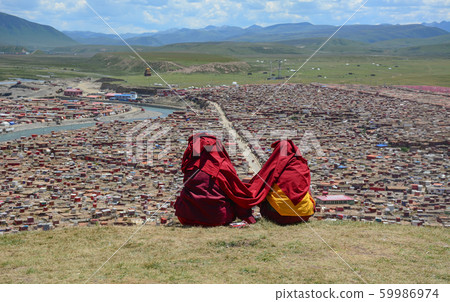 Tibetan monks sitting on the hill Tibetan monks sitting on the hill 59986974
