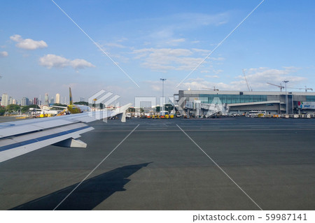 Passenger airplane docking at the airport Passenger airplane docking at the airport 59987141
