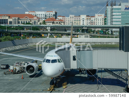 Passenger airplane docking at the airport Passenger airplane docking at the airport 59987148