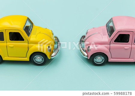 Two yellow pink vintage retro toy car isolated on 59988178