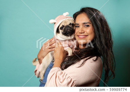Woman with pug on blank blue background Woman with pug on blank blue background 59989774