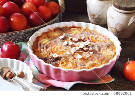 Autumn dessert. Red plums clafoutis, hazelnut and 59992001