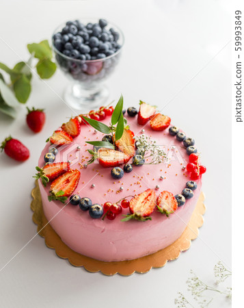 Homemade pink birthday cake decorated with berries: strawberries, blueberries, red currant and flowers. Food concept. Girl birthday or wedding cream cheese pink cake on white background Homemade pink birthday cake decorated with berries: strawberries, blueberries, red currant and flowers. Food concept. Girl birthday or wedding cream cheese pink cake on white background 59993849