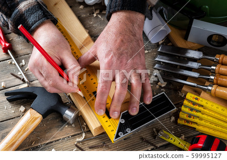 Craftsman at work on wooden boards. Carpentry. 59995127