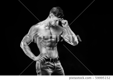 bodybuilder posing. Beautiful sporty guy male power. Fitness muscled man bodybuilder posing. Beautiful sporty guy male power. Fitness muscled man 59995152