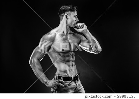 bodybuilder posing. Beautiful sporty guy male power. Fitness muscled man bodybuilder posing. Beautiful sporty guy male power. Fitness muscled man 59995153