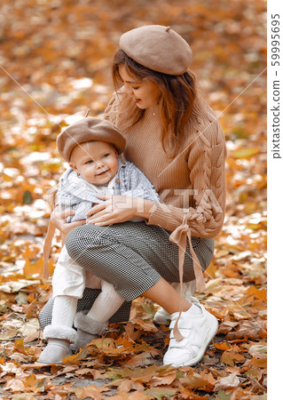 Cute and stylish family in a autumn park 59995695
