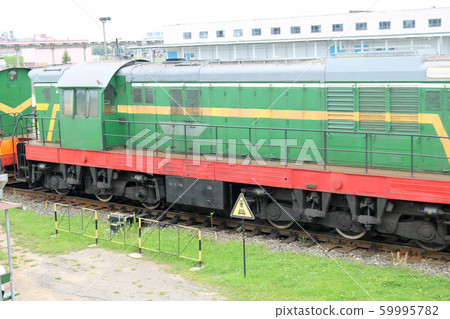 Green metallic iron wheeled freight train, 59995782