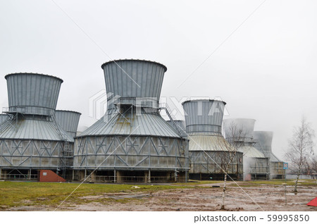 Large cooling towers in water and fog at an oil 59995850