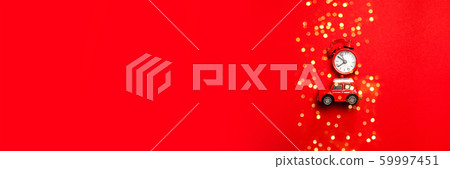 Little red toy car and red clock on a red Little red toy car and red clock on a red 59997451