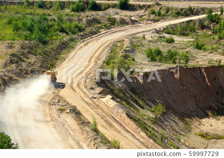 Dump truck transports sand and other minerals in the mining quarry. Dump truck transports sand and other minerals in the mining quarry. 59997729
