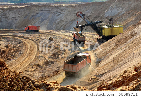 Quarry excavator loading sand or into dump truck 59998711