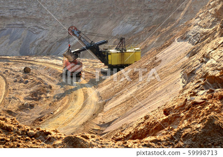 Quarry excavator loading sand or into dump truck 59998713