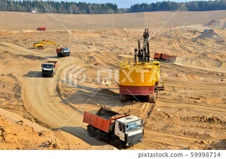 Quarry excavator loading sand or into dump truck 59998714