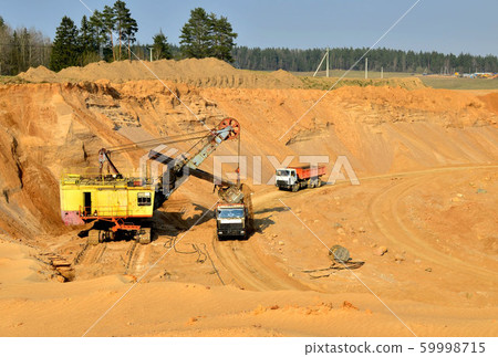 Quarry excavator loading sand into dump truck Quarry excavator loading sand into dump truck 59998715