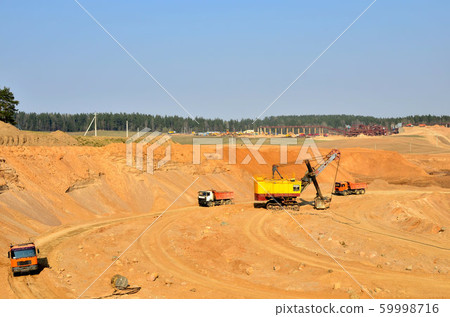 Quarry excavator loading sand or into dump truck 59998716