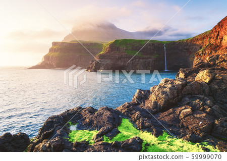 Mulafossur waterfall in Gasadalur, Vagar Island of the Faroe Islands. 59999070