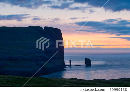 Incredible sunrise morning view on Risin og Kellingin cliffs Incredible sunrise morning view on Risin og Kellingin cliffs 59999188