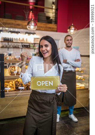 Woman wearing apron opening bakery with her successful husband Woman wearing apron opening bakery with her successful husband 59999321