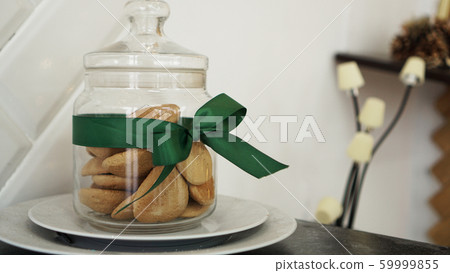Healthy cookies with dried fruits and nuts in a glass jar Healthy cookies with dried fruits and nuts in a glass jar 59999855