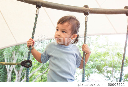 Asian little child girl having fun to climbing Asian little child girl having fun to climbing 60007621