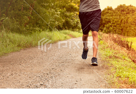 Close-up Legs of Asian young man is jogging on 60007622