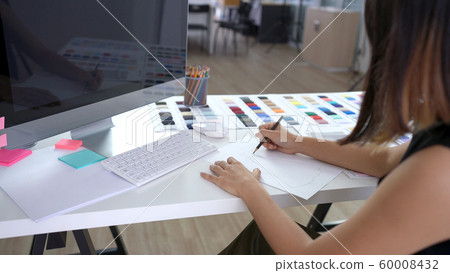 Creative designer drawing and sketching new ideas on paper in the office 60008432