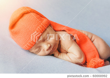 a newborn baby sleeps in a red Christmas hat on a white background. the concept of a healthy lifestyle, IVF, Christmas, new year holidays, toy a newborn baby sleeps in a red Christmas hat on a white background. the concept of a healthy lifestyle, IVF, Christmas, new year holidays, toy 60008992