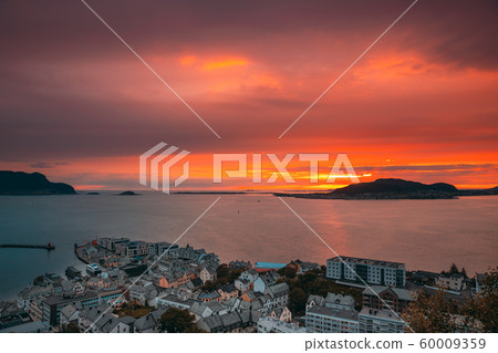 Alesund, Norway. Amazing Natural Bright Dramatic Sky In Warm Colours Above Alesund Valderoya And Islands In Sunset Time. Colorful Sky Background. Beauty In Norwegian Nature 60009359