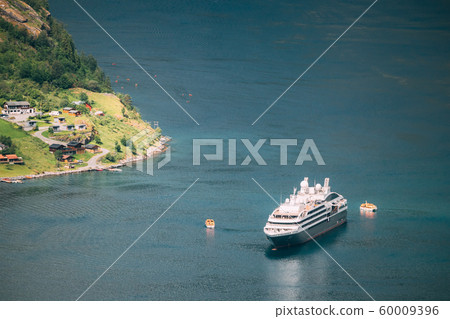 Geirangerfjord, Norway. Touristic Ship Ferry Boat Floating Liner Moored Near Geiranger In Geirangerfjorden In Spring Summer Day. Famous Norwegian Landmark And Popular Destination 60009396