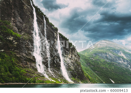 Geirangerfjord, Norway. The Seven Sisters waterfalls In Geirangerfjorden. Famous Norwegian Landmark And Popular Destination In Summer Day Geirangerfjord, Norway. The Seven Sisters waterfalls In Geirangerfjorden. Famous Norwegian Landmark And Popular Destination In Summer Day 60009413