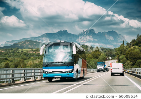 Spain. Touristic Bus Car Goes On Motorway Freeway Highway Road On Background Of Spanish Montserrat Mountain Nature Landscape Spain. Touristic Bus Car Goes On Motorway Freeway Highway Road On Background Of Spanish Montserrat Mountain Nature Landscape 60009614