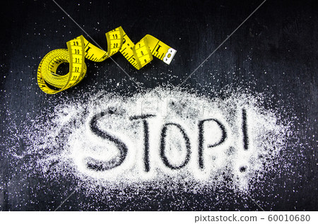 problem of excess weight, diabetes. measuring tape and sugar 60010680