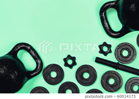 Kettlebell and dumbbell on color background. 60014173