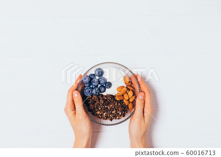 Female hands holding bowl of homemade chocolate 60016713