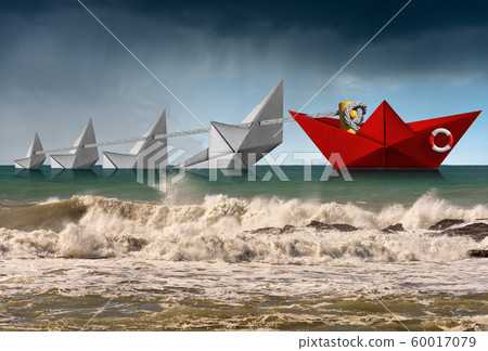 Rescue and Leadership concept - Paper boats in a rough sea Rescue and Leadership concept - Paper boats in a rough sea 60017079
