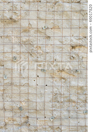 Building background prepared surface of the facade wall of the building with a fixed rusted mesh for cementing and painting the facade. Cement fixing net attached to a rough cement wall 60017820